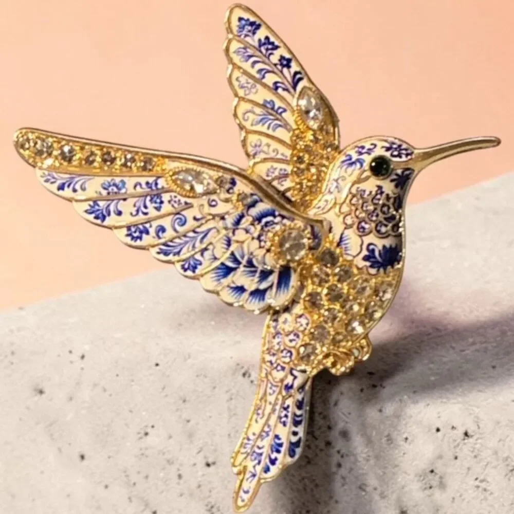 vintage-style blue and white floral enamel hummingbird brooch.
